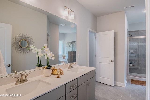 bathroom featuring vanity, tile patterned flooring, and an enclosed shower