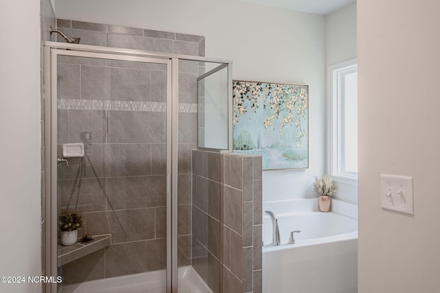 bathroom with separate shower and tub