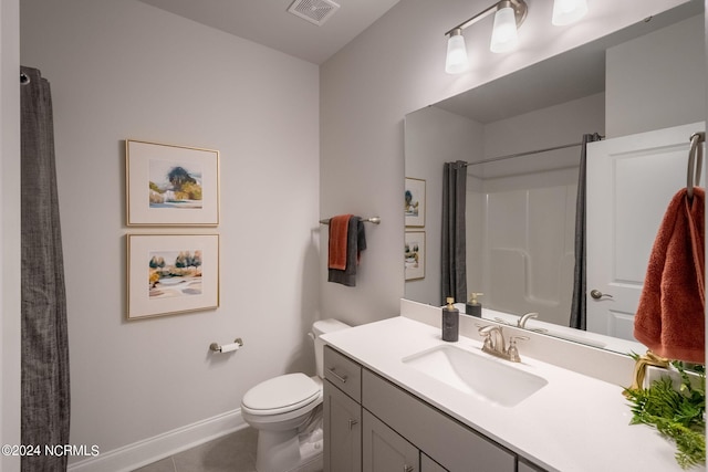 bathroom featuring tile patterned floors, vanity, and toilet