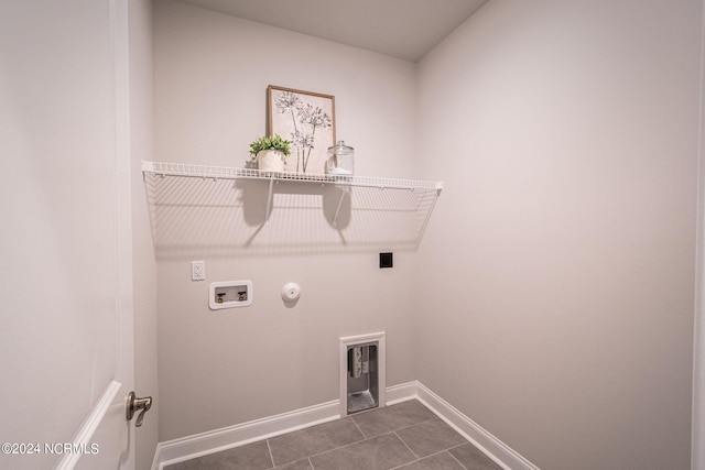 washroom featuring washer hookup, gas dryer hookup, dark tile patterned floors, and hookup for an electric dryer