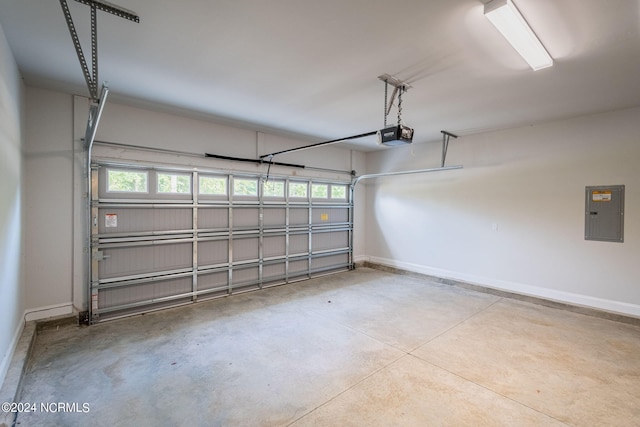 garage with a garage door opener and electric panel