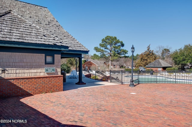 view of patio featuring fence and a fenced in pool