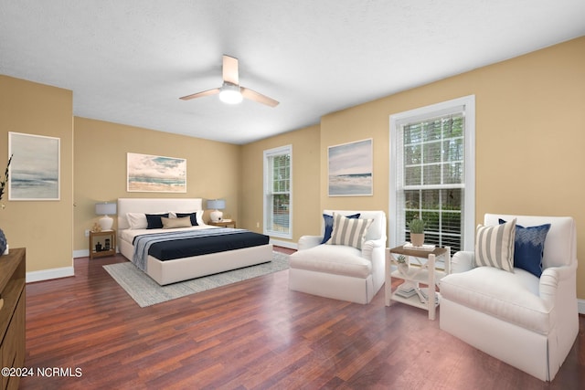 bedroom featuring ceiling fan and dark wood-type flooring