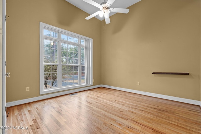 empty room featuring ceiling fan, light hardwood / wood-style floors, and lofted ceiling