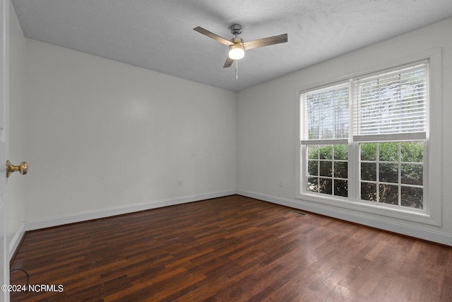 unfurnished room featuring a textured ceiling, dark hardwood / wood-style flooring, and ceiling fan