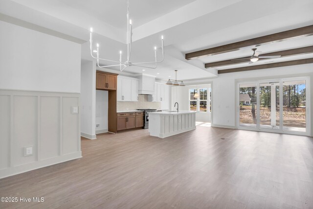 unfurnished dining area with a wealth of natural light, visible vents, light wood-style flooring, and crown molding