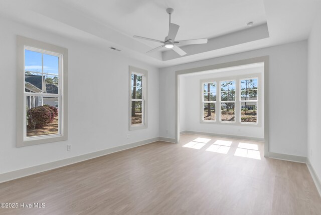 kitchen with beamed ceiling, a sink, open floor plan, light countertops, and dishwasher