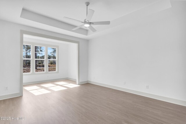 unfurnished living room featuring visible vents, a fireplace, light wood-style floors, wainscoting, and beamed ceiling