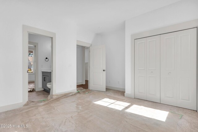 unfurnished dining area with a tray ceiling, light wood-style floors, a wainscoted wall, and a notable chandelier