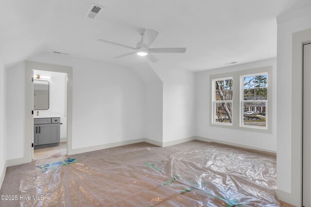 interior space featuring visible vents, beamed ceiling, wood finished floors, a fireplace, and baseboards