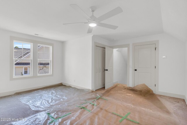 unfurnished living room with ceiling fan, visible vents, wood finished floors, and a fireplace