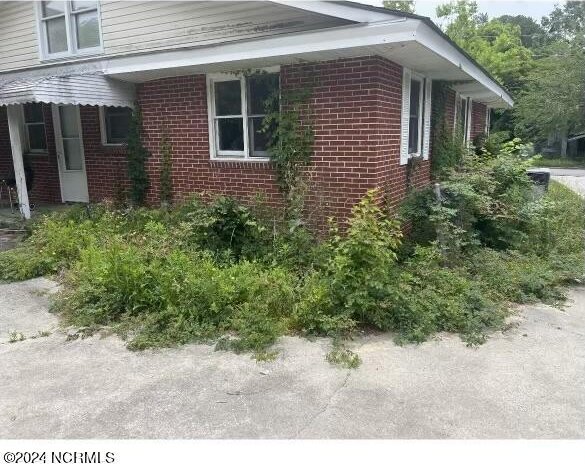 view of side of home featuring brick siding