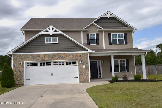 craftsman-style home featuring a garage and a front lawn