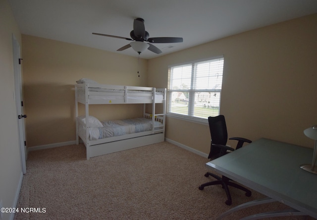 carpeted bedroom with ceiling fan and baseboards