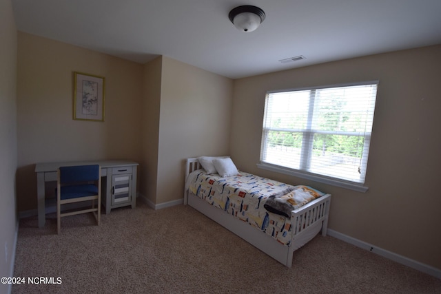 carpeted bedroom featuring visible vents and baseboards