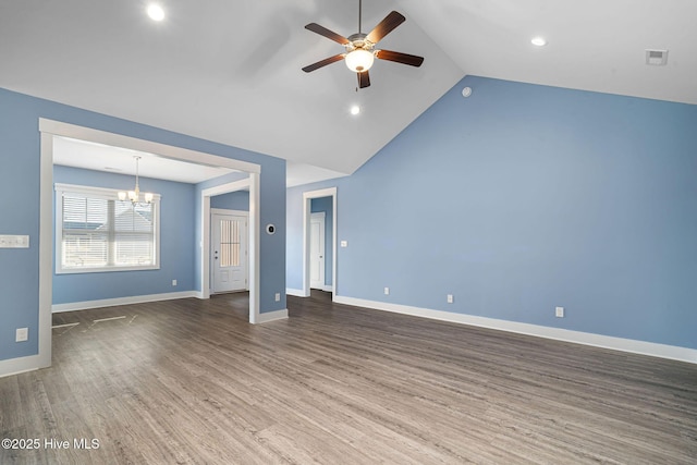 unfurnished living room featuring lofted ceiling, dark hardwood / wood-style floors, and ceiling fan with notable chandelier