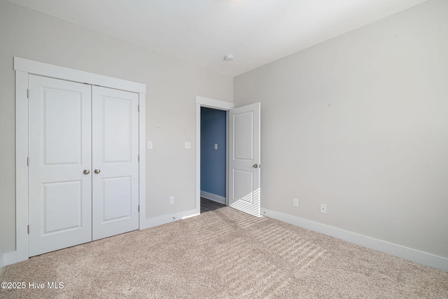 unfurnished bedroom with carpet and a closet