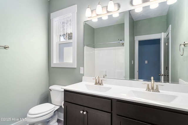 bathroom featuring toilet and vanity