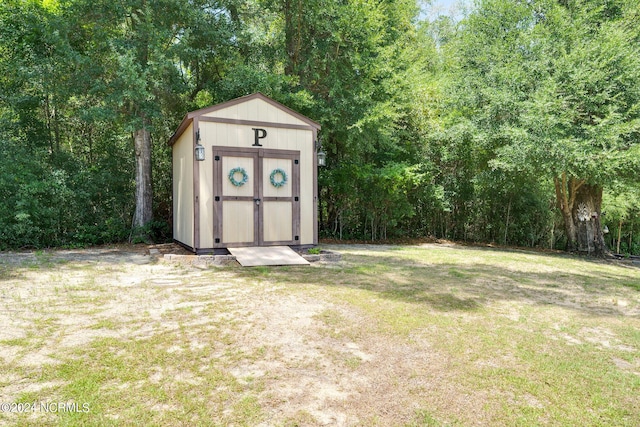 view of outdoor structure featuring a lawn