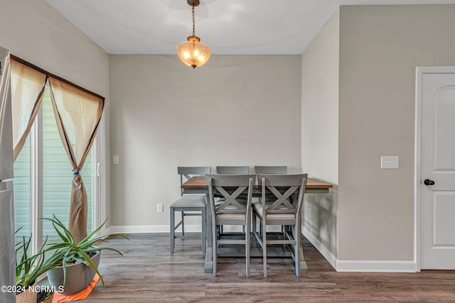 dining space with wood-type flooring