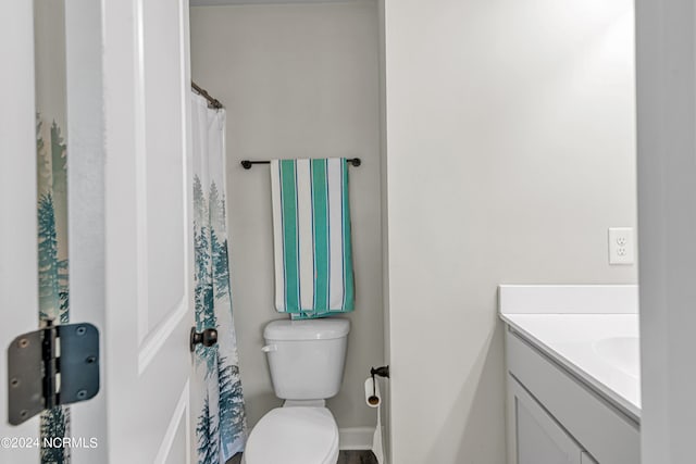 bathroom featuring vanity and toilet