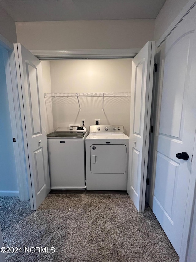 laundry room featuring dark colored carpet and separate washer and dryer