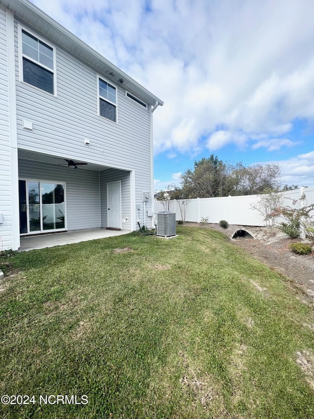 view of yard with cooling unit, a patio area, and ceiling fan