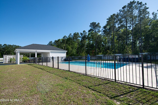 view of swimming pool featuring a patio and a lawn