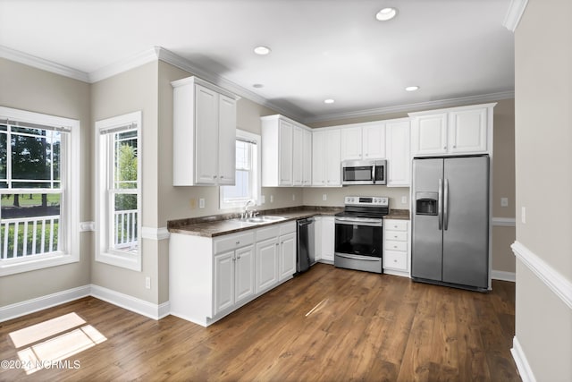 kitchen with stainless steel appliances, crown molding, sink, white cabinets, and dark hardwood / wood-style floors