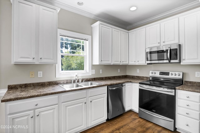 kitchen featuring white cabinetry, sink, stainless steel appliances, dark hardwood / wood-style flooring, and ornamental molding