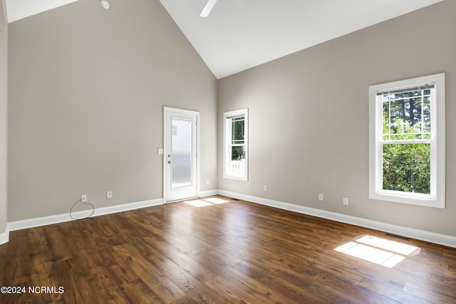 spare room featuring ceiling fan, dark hardwood / wood-style flooring, and high vaulted ceiling