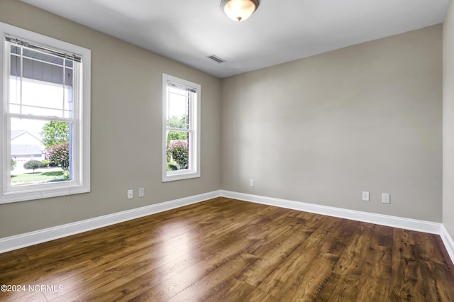 empty room featuring dark hardwood / wood-style flooring