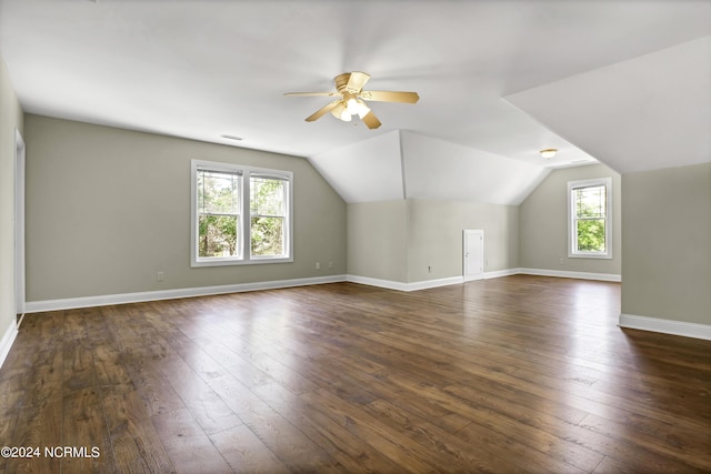 bonus room with dark hardwood / wood-style floors, a wealth of natural light, lofted ceiling, and ceiling fan