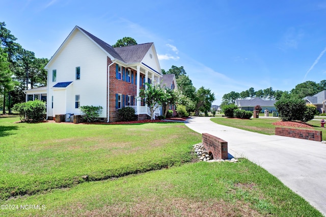 view of home's exterior with a yard and central AC