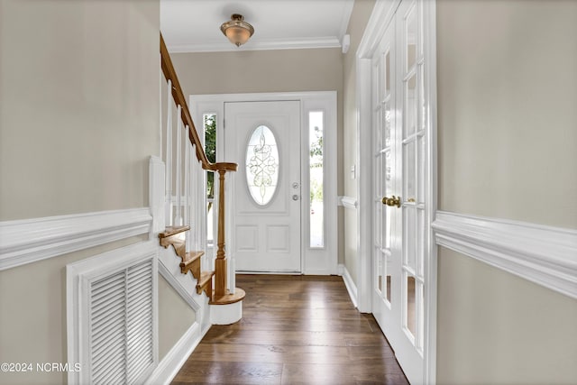 foyer entrance with dark hardwood / wood-style floors and ornamental molding