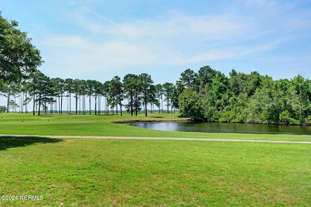 view of home's community featuring a lawn and a water view