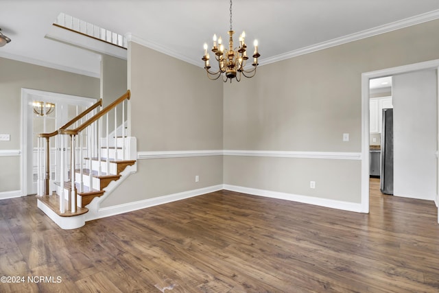 unfurnished room with dark hardwood / wood-style floors, crown molding, and a chandelier