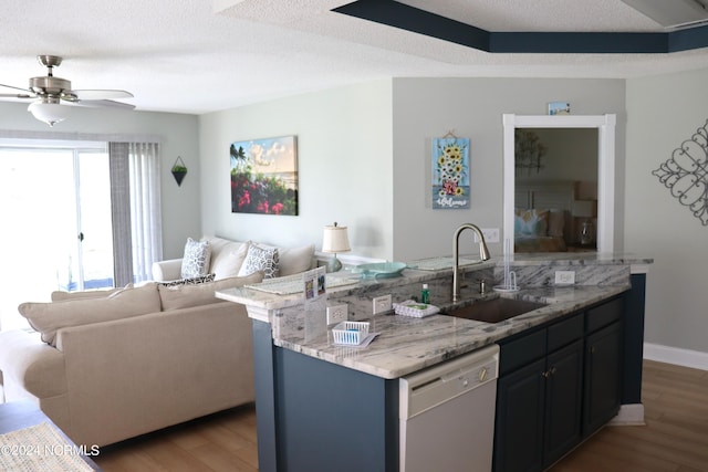 kitchen featuring wood-type flooring, white dishwasher, ceiling fan, sink, and light stone counters