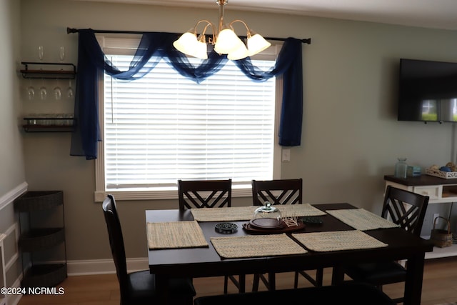 dining area with an inviting chandelier and hardwood / wood-style floors