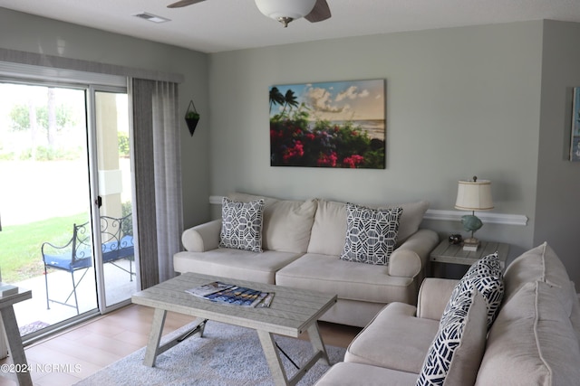 living room featuring ceiling fan and hardwood / wood-style flooring