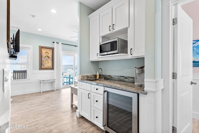 445 E Third St, Ocean Isle Beach, NC 28469 - kitchen featuring beverage cooler, stainless steel microwave, a sink, white cabinetry, and recessed lighting