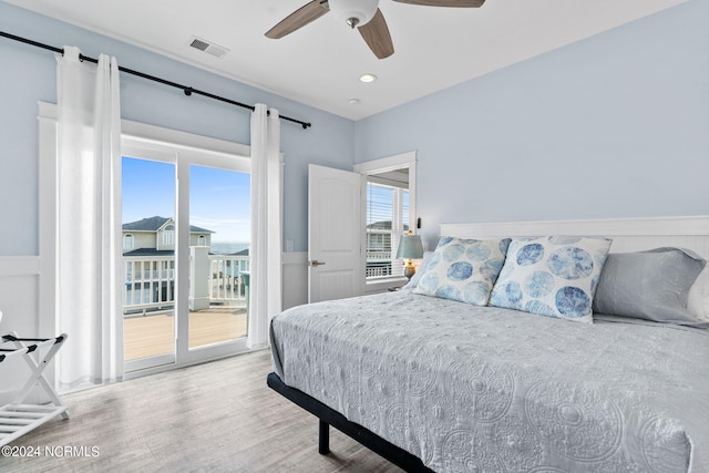 445 E Third St, Ocean Isle Beach, NC 28469 - bedroom featuring access to outside, wood finished floors, ceiling fan, and a barn door