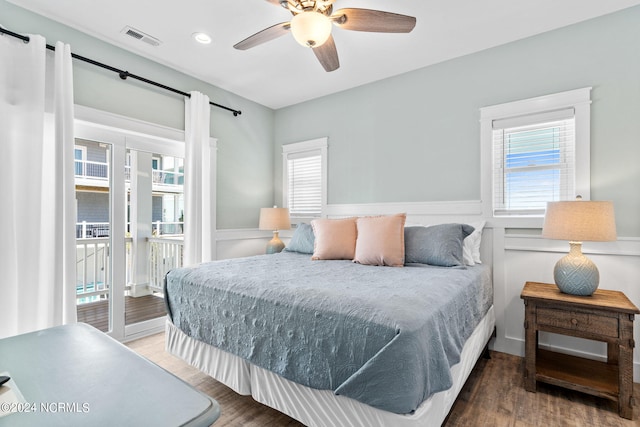 445 E Third St, Ocean Isle Beach, NC 28469 - bedroom with access to exterior, wood finished floors, a wainscoted wall, ceiling fan, and recessed lighting