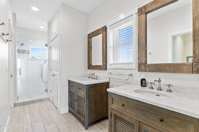445 E Third St, Ocean Isle Beach, NC 28469 - bathroom featuring a shower stall, plenty of natural light, two vanities, and recessed lighting