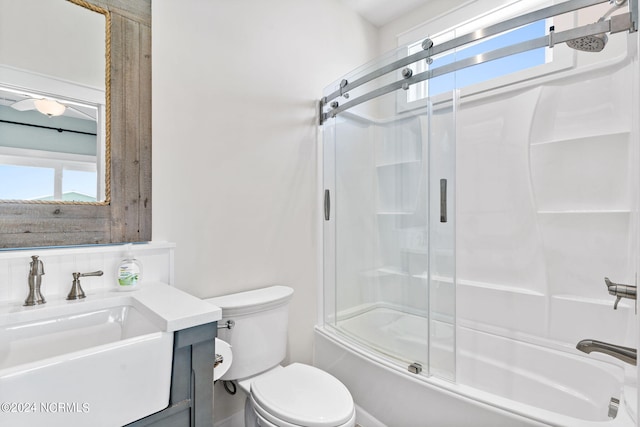 445 E Third St, Ocean Isle Beach, NC 28469 - full bath with bath / shower combo with glass door, toilet, vanity, and plenty of natural light
