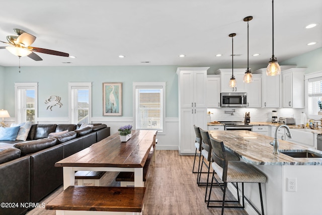 445 E Third St, Ocean Isle Beach, NC 28469 - living area featuring light wood-style flooring, wainscoting, ceiling fan, and recessed lighting