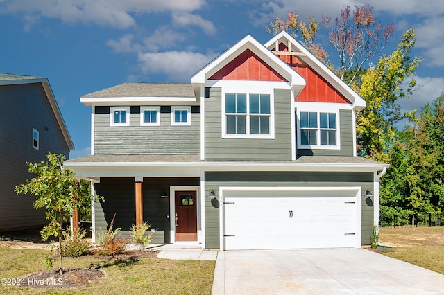 craftsman-style house with a front lawn and a garage