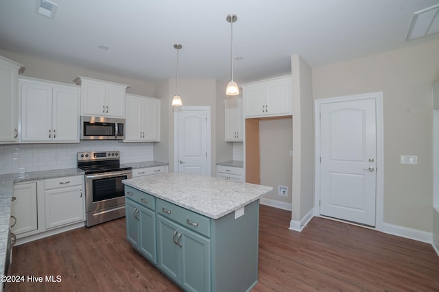 kitchen with white cabinetry, dark hardwood / wood-style flooring, a kitchen island, and appliances with stainless steel finishes