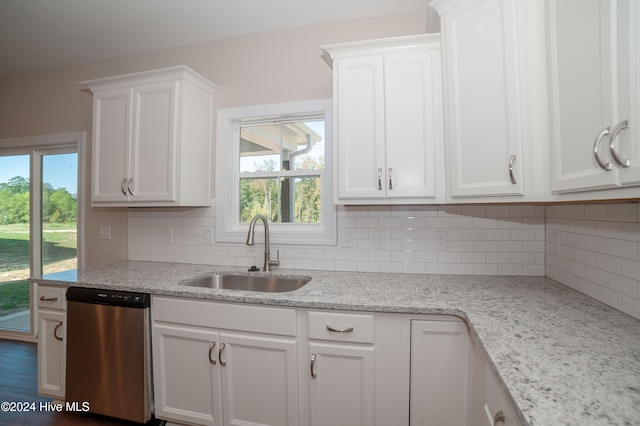 kitchen featuring white cabinetry, stainless steel dishwasher, a healthy amount of sunlight, and sink