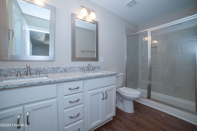 bathroom with vanity, toilet, wood-type flooring, and walk in shower